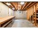 Unfinished basement with exposed beams, concrete walls, and a workbench at 12579 Appaloosa Pl, Broomfield, CO 80020