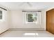 Bright bedroom featuring neutral carpet, a ceiling fan, and a large window at 12579 Appaloosa Pl, Broomfield, CO 80020