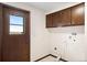 Laundry room with cabinetry, a tiled floor, utility hookups, and a window overlooking the yard at 12579 Appaloosa Pl, Broomfield, CO 80020