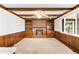 The living room features a brick fireplace and built-in bookshelves, ceiling fan and beamed ceiling at 12579 Appaloosa Pl, Broomfield, CO 80020