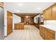 Open-concept living room showcases beamed ceiling, fireplace, and seamless transition to the kitchen at 12579 Appaloosa Pl, Broomfield, CO 80020