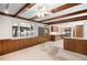 Bright living room features beams, hardwood panels and a view into the eat in kitchen at 12579 Appaloosa Pl, Broomfield, CO 80020