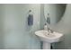 Powder room boasts sleek pedestal sink, framed mirror, and modern fixtures at 4785 Aberdeen Ave, Highlands Ranch, CO 80126