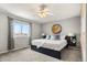 Relaxing bedroom boasts plush carpeting, modern light fixtures, and large window at 4785 Aberdeen Ave, Highlands Ranch, CO 80126