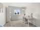 Bright bedroom features a large window, gray carpet and white furniture that provides a calming and functional space at 4785 Aberdeen Ave, Highlands Ranch, CO 80126