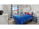 Nautical-themed bedroom with blue accents, a whiteboard, and a Spiderman comforter creates a fun and vibrant space at 4785 Aberdeen Ave, Highlands Ranch, CO 80126