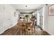 Cozy dining area with a round wooden table and views of the kitchen and backyard at 4785 Aberdeen Ave, Highlands Ranch, CO 80126