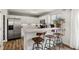 Modern kitchen featuring white cabinets, stainless steel appliances, and a breakfast bar with seating at 4785 Aberdeen Ave, Highlands Ranch, CO 80126
