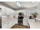 Bright kitchen features white cabinets, stainless steel appliances, and a well-lit workspace at 4785 Aberdeen Ave, Highlands Ranch, CO 80126