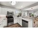 Bright kitchen features white cabinets, stainless steel appliances, and hardwood floors at 4785 Aberdeen Ave, Highlands Ranch, CO 80126