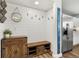 Functional mudroom features shiplap accent wall, storage bench, and hardwood floors at 4785 Aberdeen Ave, Highlands Ranch, CO 80126