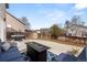 Back patio with grill and fire pit, perfect for outdoor entertaining and relaxation, surrounded by privacy fence at 4785 Aberdeen Ave, Highlands Ranch, CO 80126