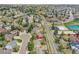 An aerial view of a home with mature trees, fencing, and a neighborhood pool nearby at 5668 S Rifle Ct, Centennial, CO 80015