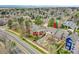 An aerial view of a house with a manicured backyard, surrounded by lush greenery and fencing at 5668 S Rifle Ct, Centennial, CO 80015