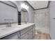 Bathroom featuring a double vanity, modern lighting, and a tub-shower combo at 5668 S Rifle Ct, Centennial, CO 80015