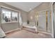 Bright bathroom featuring a bathtub with steps, and a glass door shower at 5668 S Rifle Ct, Centennial, CO 80015