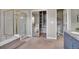 Bathroom featuring a shower with glass doors and bathtub, with a mirrored closet at 5668 S Rifle Ct, Centennial, CO 80015