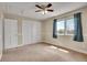 Bedroom with standard closet doors, carpeted floors, and natural light from the window at 5668 S Rifle Ct, Centennial, CO 80015