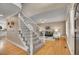 Inviting foyer leading to a living room with hardwood floors, stairs, and an open floor plan at 5668 S Rifle Ct, Centennial, CO 80015