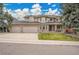 Charming two-story home with a three-car garage, brick facade, and a well-manicured front yard at 5668 S Rifle Ct, Centennial, CO 80015