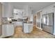 Bright kitchen featuring white cabinets, stainless steel appliances, and tile flooring at 5668 S Rifle Ct, Centennial, CO 80015