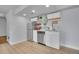 Cozy kitchenette features stainless steel appliances, white cabinets, and light wood flooring at 5668 S Rifle Ct, Centennial, CO 80015