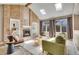 Sunlit living room with brick fireplace, vaulted ceiling, and built-in shelving at 5668 S Rifle Ct, Centennial, CO 80015