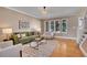 Comfortable living room featuring an area rug, natural light, and hardwood floors at 5668 S Rifle Ct, Centennial, CO 80015