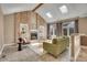Inviting living room featuring a brick fireplace, vaulted ceilings, and abundant natural light at 5668 S Rifle Ct, Centennial, CO 80015