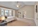 Large main bedroom with bay window, ceiling fan, and en suite bathroom at 5668 S Rifle Ct, Centennial, CO 80015