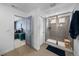 A contemporary bathroom features a glass-enclosed shower and easy access to the primary bedroom at 8109 Mount Ouray Rd, Littleton, CO 80125
