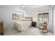 Bright bedroom has a rocking chair, neutral carpet and paint, and lots of natural light at 8109 Mount Ouray Rd, Littleton, CO 80125