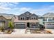 Charming two-story home with a well-manicured front yard, covered porch, and attached two-car garage at 8109 Mount Ouray Rd, Littleton, CO 80125