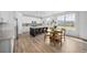Modern kitchen features a center island with seating and an adjacent breakfast nook with beautiful light at 8109 Mount Ouray Rd, Littleton, CO 80125