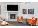 Cozy living area with a modern fireplace, a mounted TV, and comfortable seating for relaxing and entertaining at 8109 Mount Ouray Rd, Littleton, CO 80125