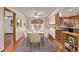 Elegant dining room with a modern table set for six, adjacent to the kitchen at 6505 W 46Th Pl, Wheat Ridge, CO 80033