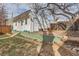 View of the detached garage in the backyard with stone steps and a garden bed at 1006 S Emerson St, Denver, CO 80209