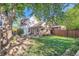 Rear exterior view features a patio, lawn, garden, string lights and grassy backyard at 1006 S Emerson St, Denver, CO 80209