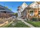 The rear exterior view features a patio, lawn, garden, and string lights over the grassy backyard at 1006 S Emerson St, Denver, CO 80209