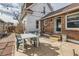 Backyard patio with table and seating near brick home at 1006 S Emerson St, Denver, CO 80209