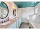 Bathroom featuring double sinks, marble countertops, and subway tile at 1006 S Emerson St, Denver, CO 80209