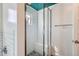 Bathroom boasts a glass shower with white subway tile, dark patterned floors, and a blue-painted ceiling at 1006 S Emerson St, Denver, CO 80209