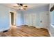 Spacious bedroom featuring hardwood floors, ceiling fan, and white trim accents at 1006 S Emerson St, Denver, CO 80209