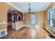 Open dining room with hardwood floors, pendant lighting, and easy access to kitchen at 1006 S Emerson St, Denver, CO 80209