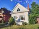 Charming home with a white exterior, manicured lawn, and inviting front porch at 1006 S Emerson St, Denver, CO 80209