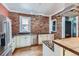 Modern kitchen featuring brick walls, stainless steel appliances, and granite countertops at 1006 S Emerson St, Denver, CO 80209