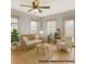 Staged living room features a couch, chair, rug, and natural light at 1006 S Emerson St, Denver, CO 80209