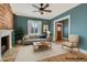 Inviting living room with exposed brick wall, hardwood floors, and updated furniture at 1006 S Emerson St, Denver, CO 80209