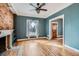 Cozy living room boasts hardwood floors, brick fireplace, and large window for ample natural light at 1006 S Emerson St, Denver, CO 80209