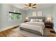 This staged main bedroom boasts a large window and elegant decor at 1006 S Emerson St, Denver, CO 80209
